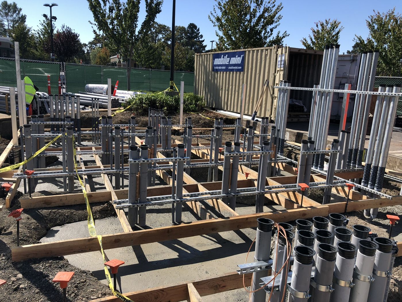 Formed equipment pads with conduit stub-ups racked on strut, ready for the concrete pour